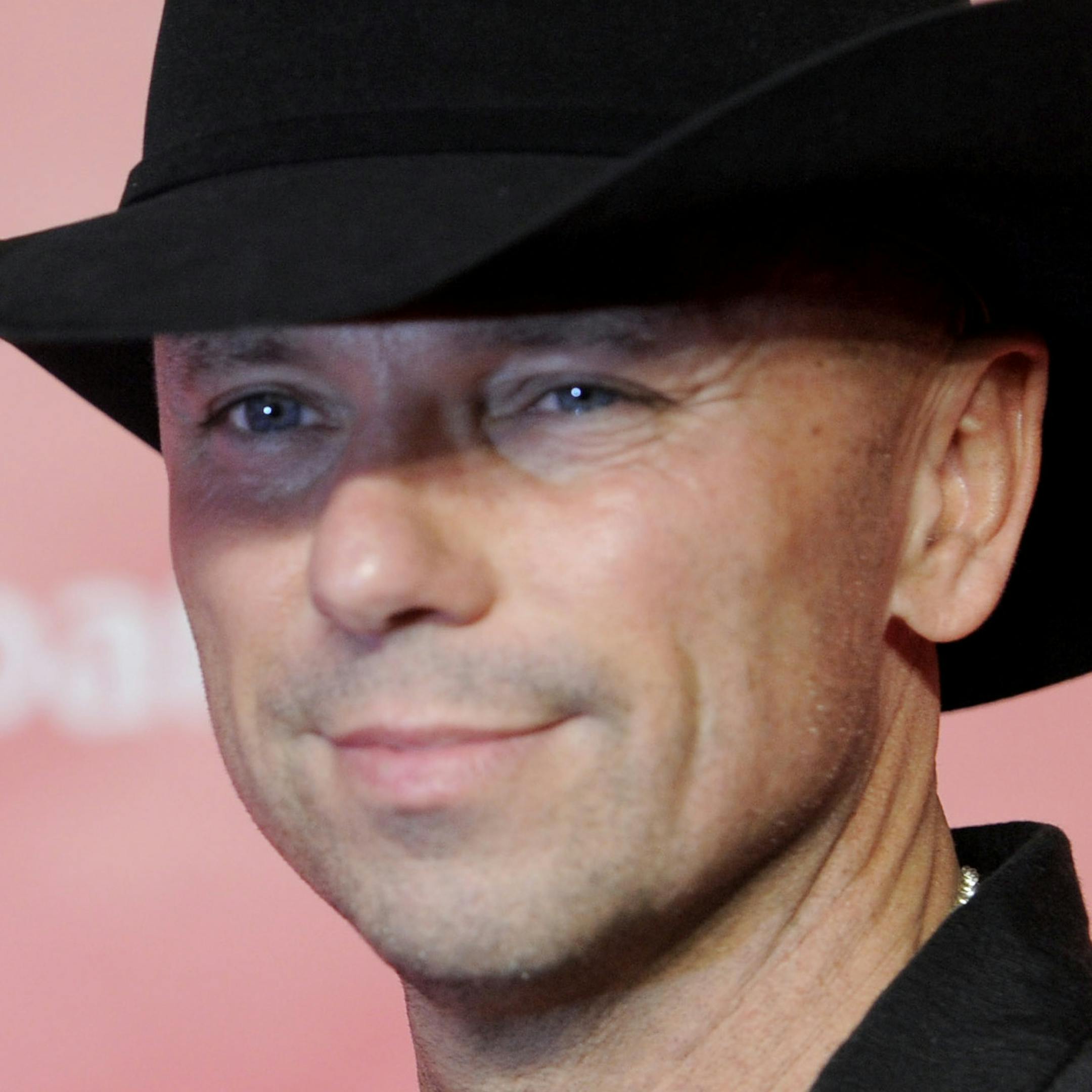 FILE - This Feb. 8, 2013 file photo shows Kenny Chesney at the MusiCares Person of the Year tribute honoring Bruce Springsteen at the Los Angeles Convention Center in Los Angeles. Chesney announced, Tuesday, April 30, that proceeds from the downloaded single sales of ìSpread The Love,î his track co-written and recorded with the Wailers, will go to his newly created the Spread the Love fund, which will benefit post-acute care for victims of traumatic injuries from the Boston Marathon bo