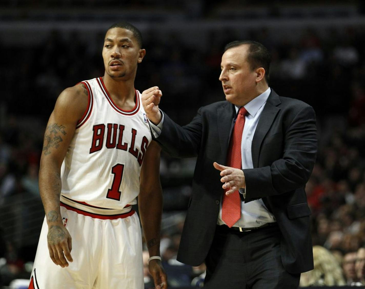 Chicago Bulls point guard Derrick Rose (1) talks with head coach Tom Thibodeau during the first half of an NBA game against the Detroit Pistons at the United Center in Chicago, Illinois, on Monday, January 9, 2012.