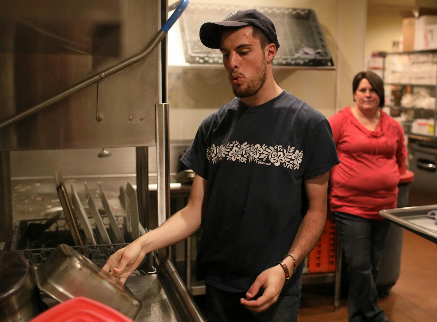 Like thousands of other high school graduates in Minnesota, Chris McIntire went straight to work at a segregated workshop, where he did menial factory work for sub minimum wages. Then in 2017, the state Vocational Rehabilitation program stepped in and found Chris a job for $10/hour at Friendly Buffalo Restaurant in Big Lake, Minn. Here, McIntire whistles to the Bob Dylan song The Times They Are a Changing', while washing dishes with his job coach Jaime Klatt looking on Friday, May 11, 2018, at t