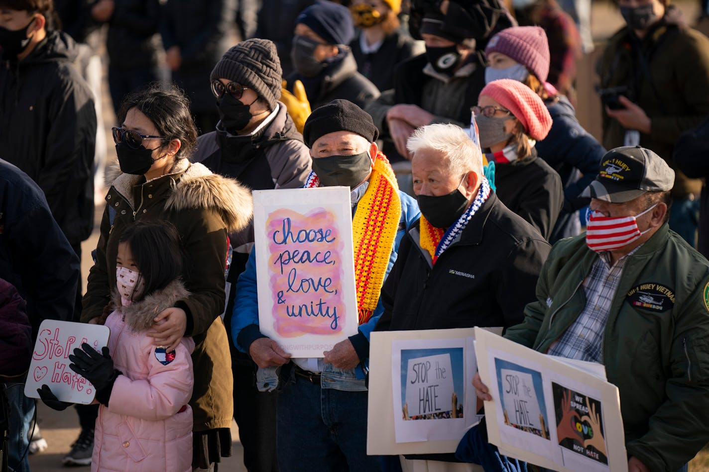 Toan Nguyen, Khon Luu, and Nhiem Huynh, from right, were among the hundreds who gathered in front of the State Capital late Sunday, March 28, 2021. Hundreds of Asian Americans and supporting communities gathered in front of the State Capital to remember the victims of the Atlanta Killings with speeches, pledges, performances, and a candlelight vigil. (Jeff Wheeler/Star Tribune via AP)