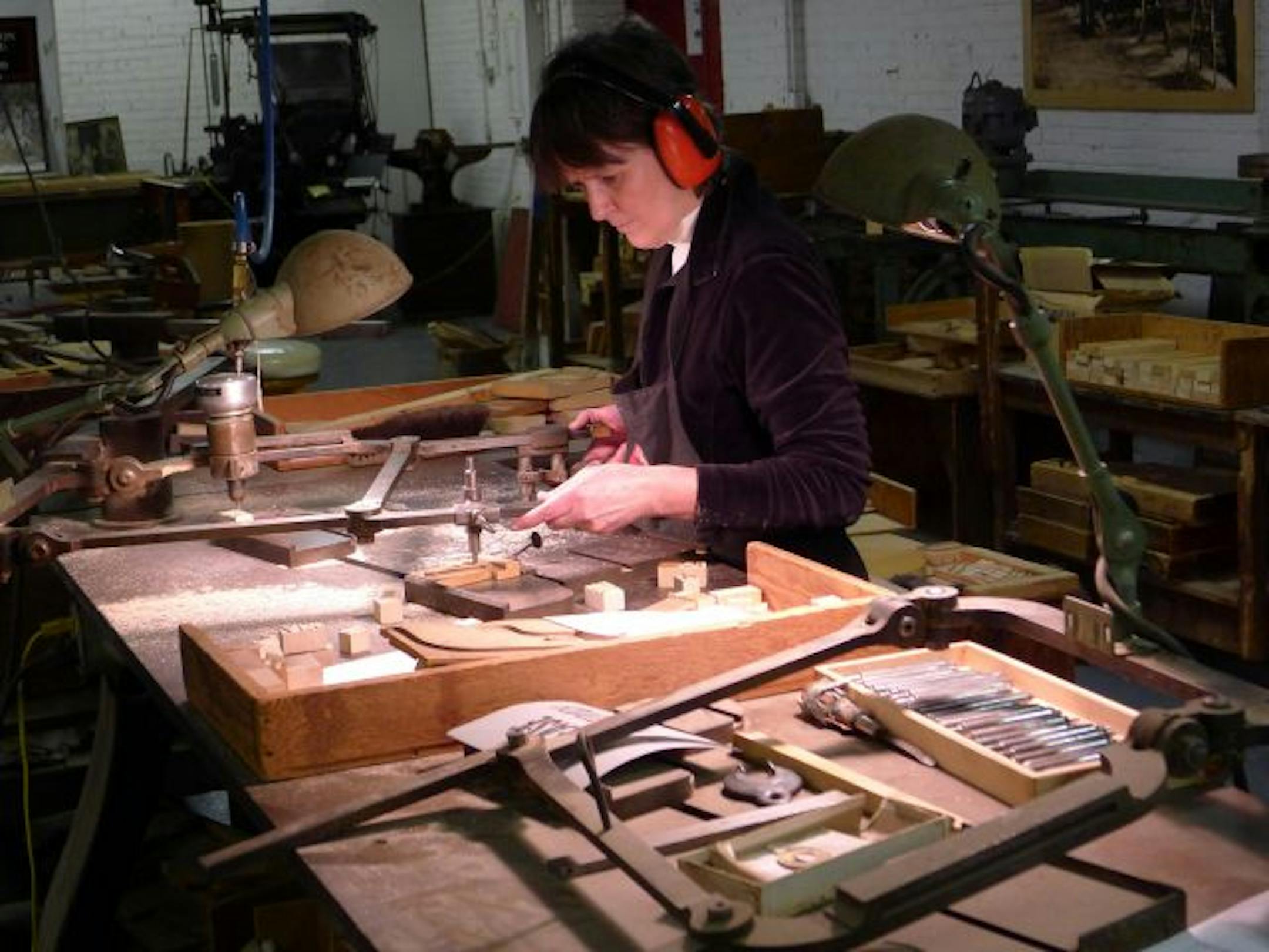 Georgianne Liesch cuts type at the Hamilton Wood Type & Printing Museum in Two Rivers, Wisconsin. The museum is home to 1.5 million pieces of wood type, the largest collection in the country, and functions as a working studio for artists, designers and typeface enthusiasts.