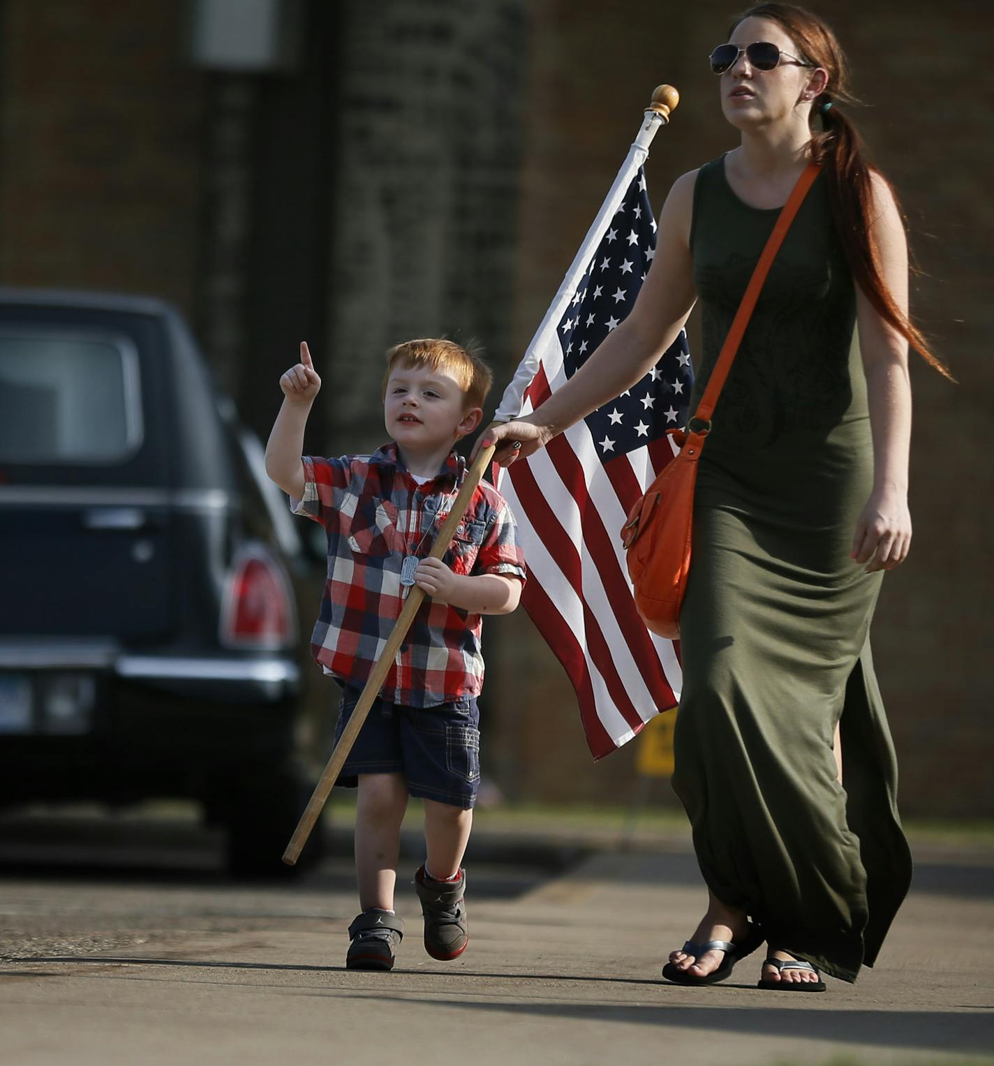 Caitlin Brown walked with her 4- year-old son Caden Haver to attend the visitation for slain Mendota Heights police officer Scott Patrick at St. Stephen's Lutheran Church Tuesday August 5 , 2014 in West St. Paul , MN . Caitlin who lives in West St. Paul said that she was "showing tier respect for those who keep them safe, especially the little ones".] Jerry Holt Jerry.holt@startribune.com