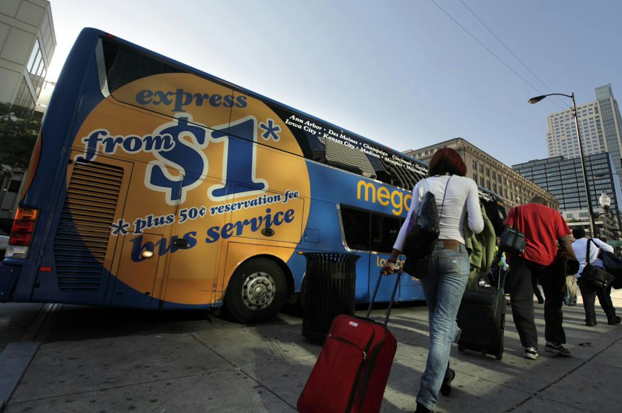 People wait to board a Megabus on South Canal Street in Chicago, Illinois,August 27, 2012. Megabus is an intercity bus service.