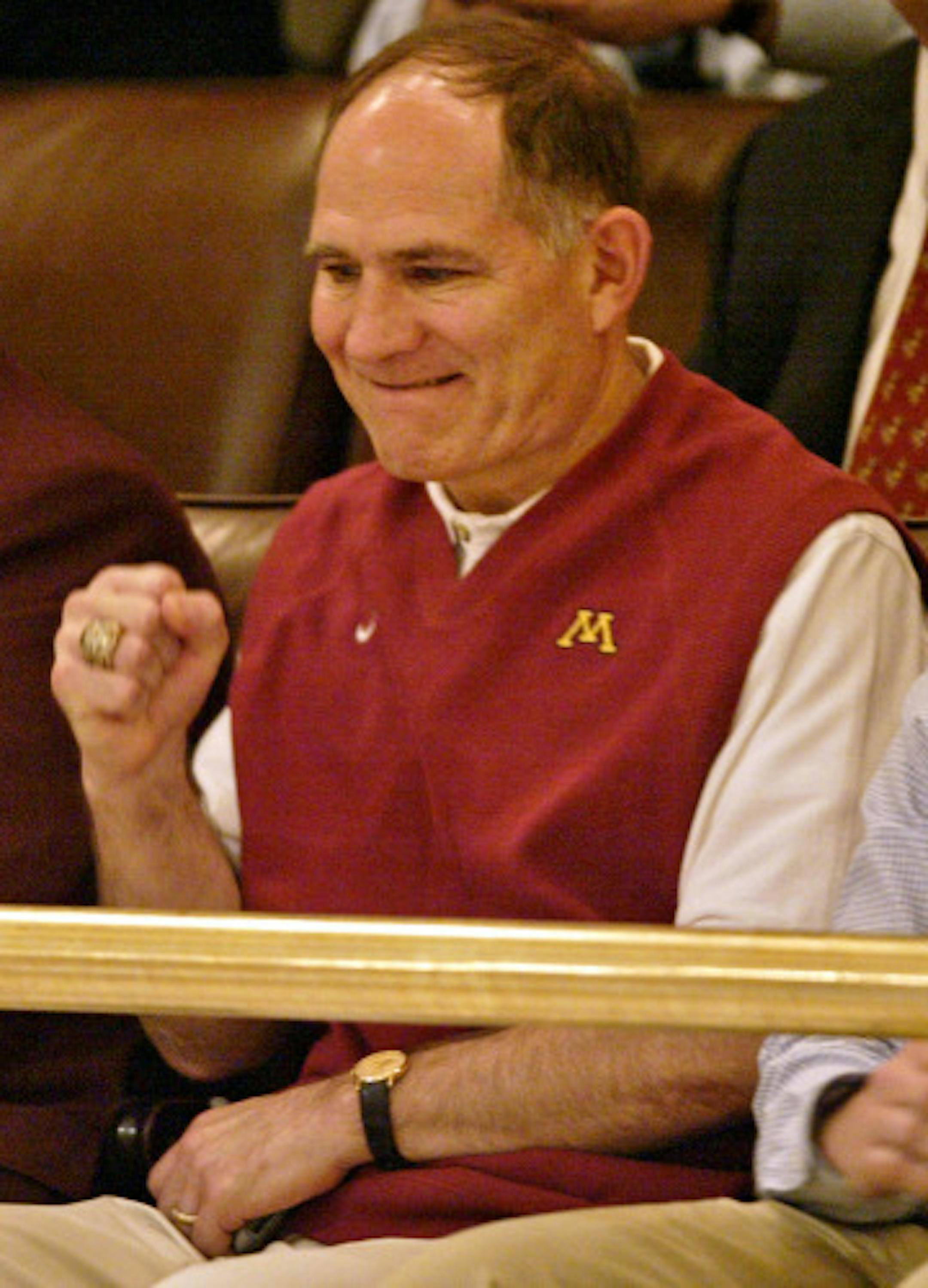 Gophers Athletic Director Joel Maturi gives a clenched-fist victory salute as the final tally of a vote on the House floor is announced as supporting the stadium finance bill.