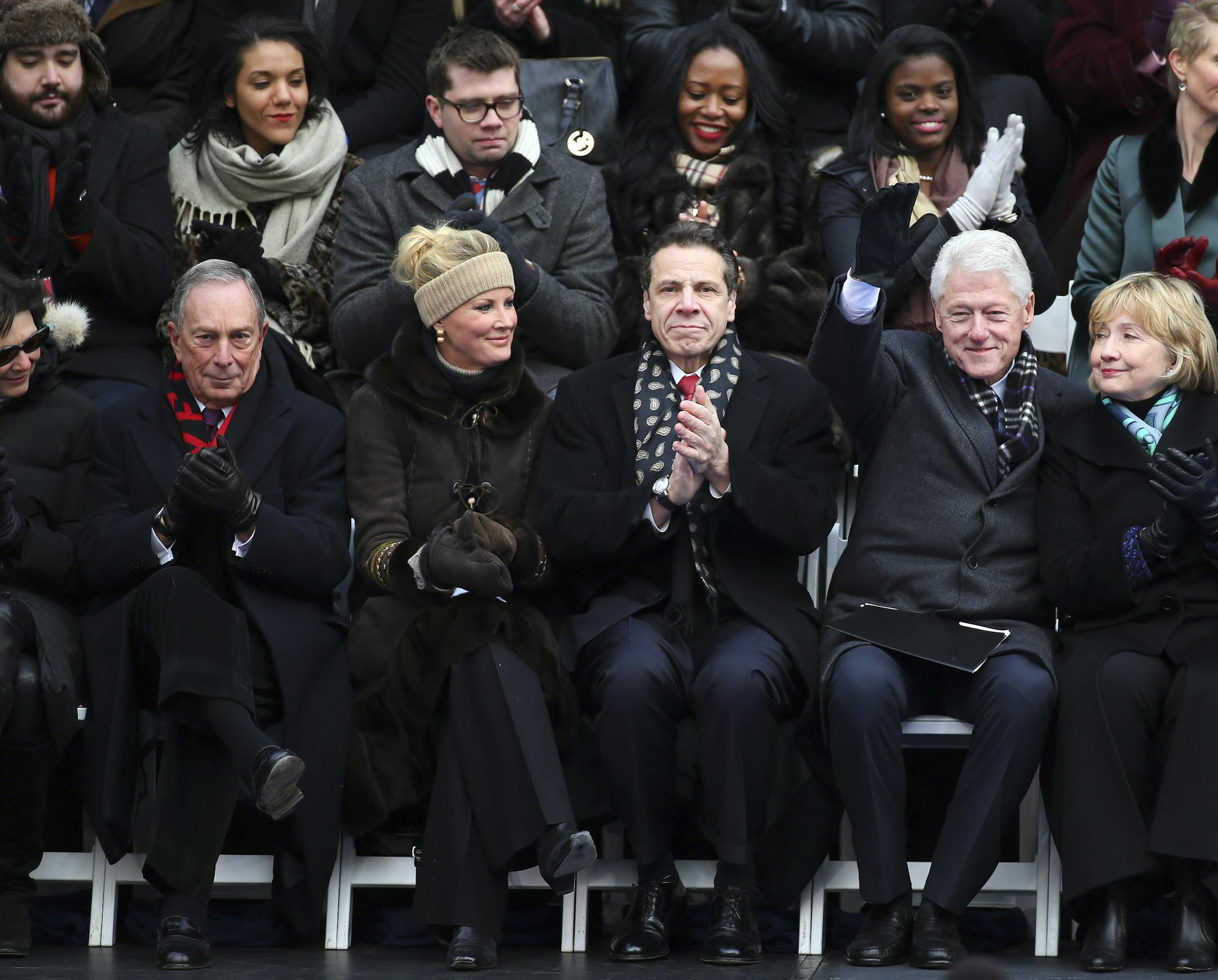 New York Gov. Andrew Cuomo, center, applauds at the inauguration of Mayor Bill de Blasio in New York, Jan. 1, 2014. Front row, from right: former Secretary of State Hillary Clinton and former President Bill Clinton, Cuomo, Cuomo's girlfriend Sandra Lee, former mayor Michael Bloomberg and Bloomberg's girlfriend, Diana Taylor. (Chang W. Lee/The New York Times)