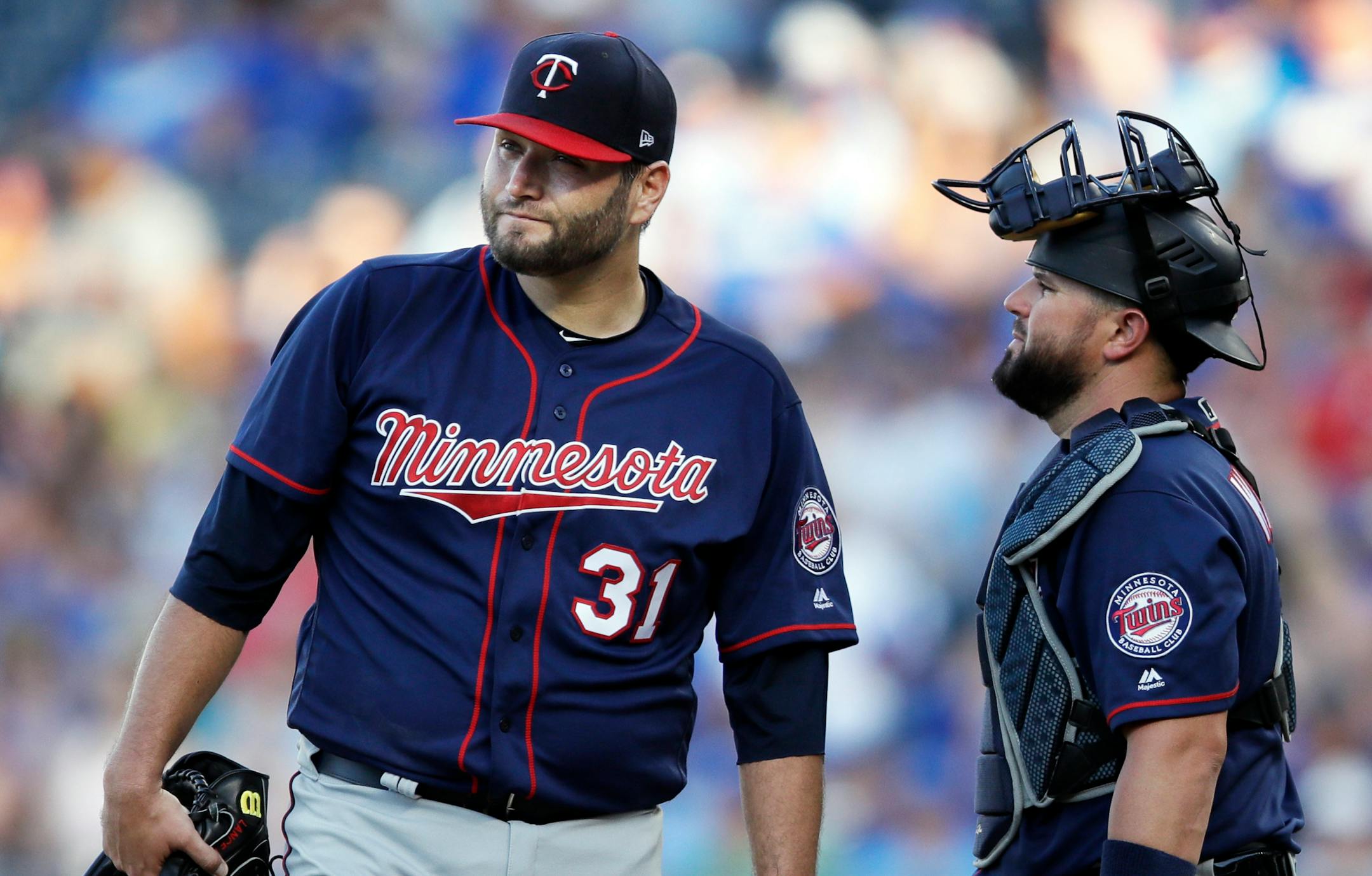 Twins starting pitcher Lance Lynn (31) and catcher Bobby Wilson, right, talk after the Kansas City Royals loaded the bases during the third inning