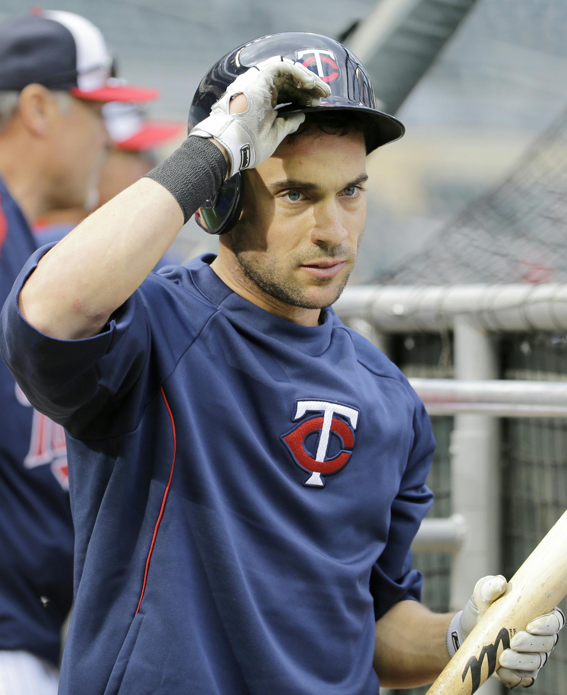 Minnesota Twins center fielder Sam Fuld puts on his batting helmet before a baseball game against the Detroit Tigers in Minneapolis, Friday, April 25, 2014. (AP Photo/Ann Heisenfelt) ORG XMIT: OTKAH103