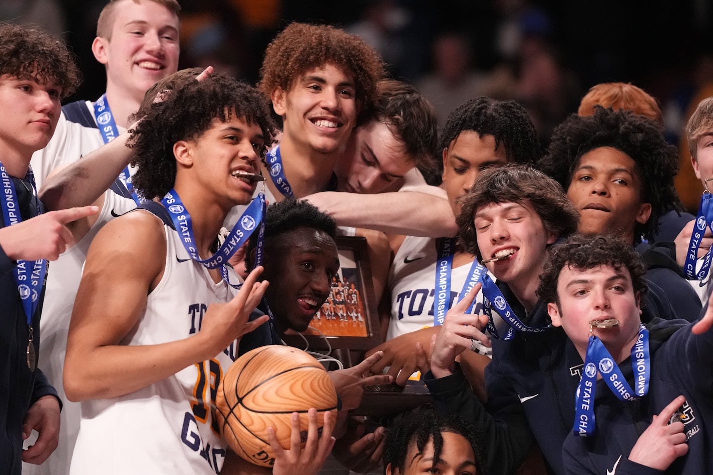 Totino-Grace players celebrated with their first place trophy after winning the MSHSL boys basketball Class 3A state championship game between Totino-Grace and DeLaSalle Saturday, March 26, 2022 at Williams Arena in Minneapolis. ] ANTHONY SOUFFLE • anthony.souffle@startribune.com