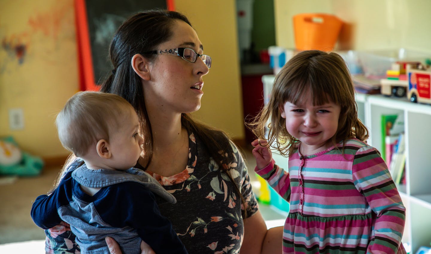 Erin Werley, 37, consoled her daughter Maddie, 2, while holding 8-month-old Leo at their home in Munster, Ind.