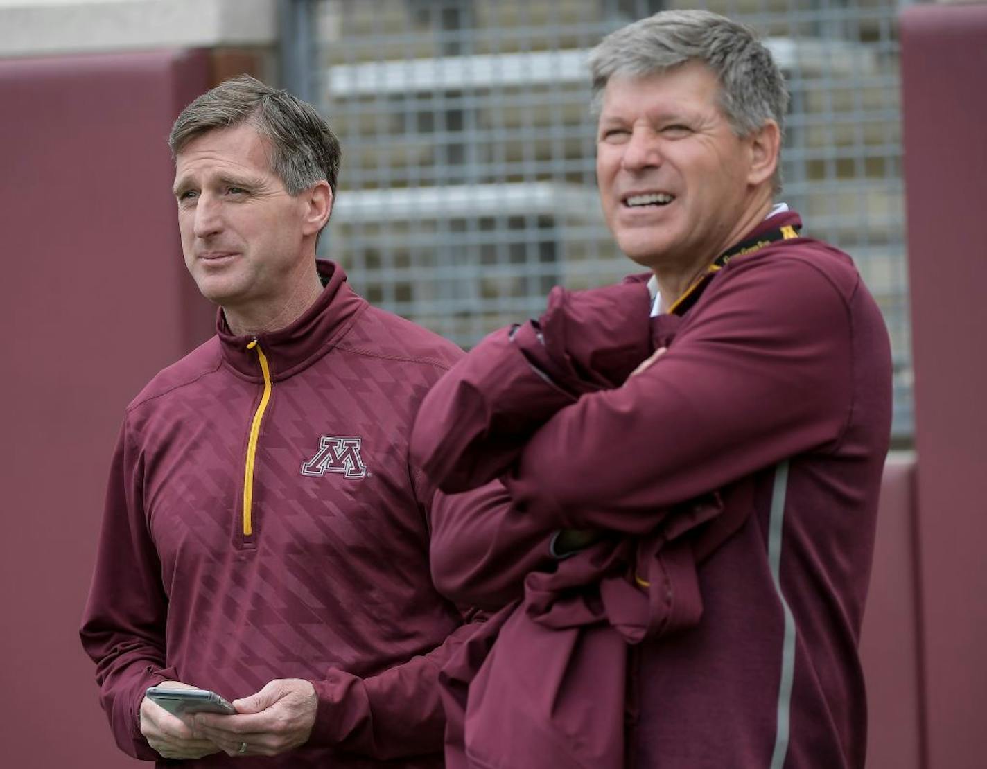 University of Minnesota Athletic Director Mark Coyle joked with athletics fundraiser Randy Handel on the sidelines of Minnesota football's spring game in mid-April.