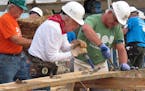Former President Jimmy Carter, center, works on a Habitat for Humanity construction project on Monday, Aug. 22, 2016 in Memphis, Tenn. On Monday, Cart