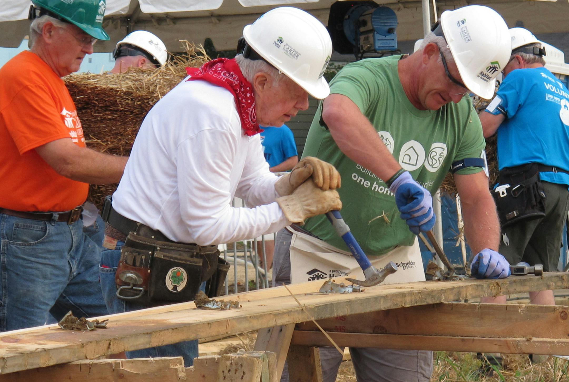 Former President Jimmy Carter, center, works on a Habitat for Humanity construction project on Monday, Aug. 22, 2016 in Memphis, Tenn. On Monday, Carter said he thought he had just a few weeks to live during his battle with cancer a year ago. "Now I feel pretty certain about my cure and the cancer being in remission, but the doctors are still keeping an eye on me," he said. (AP Photo/Adrian Sainz)