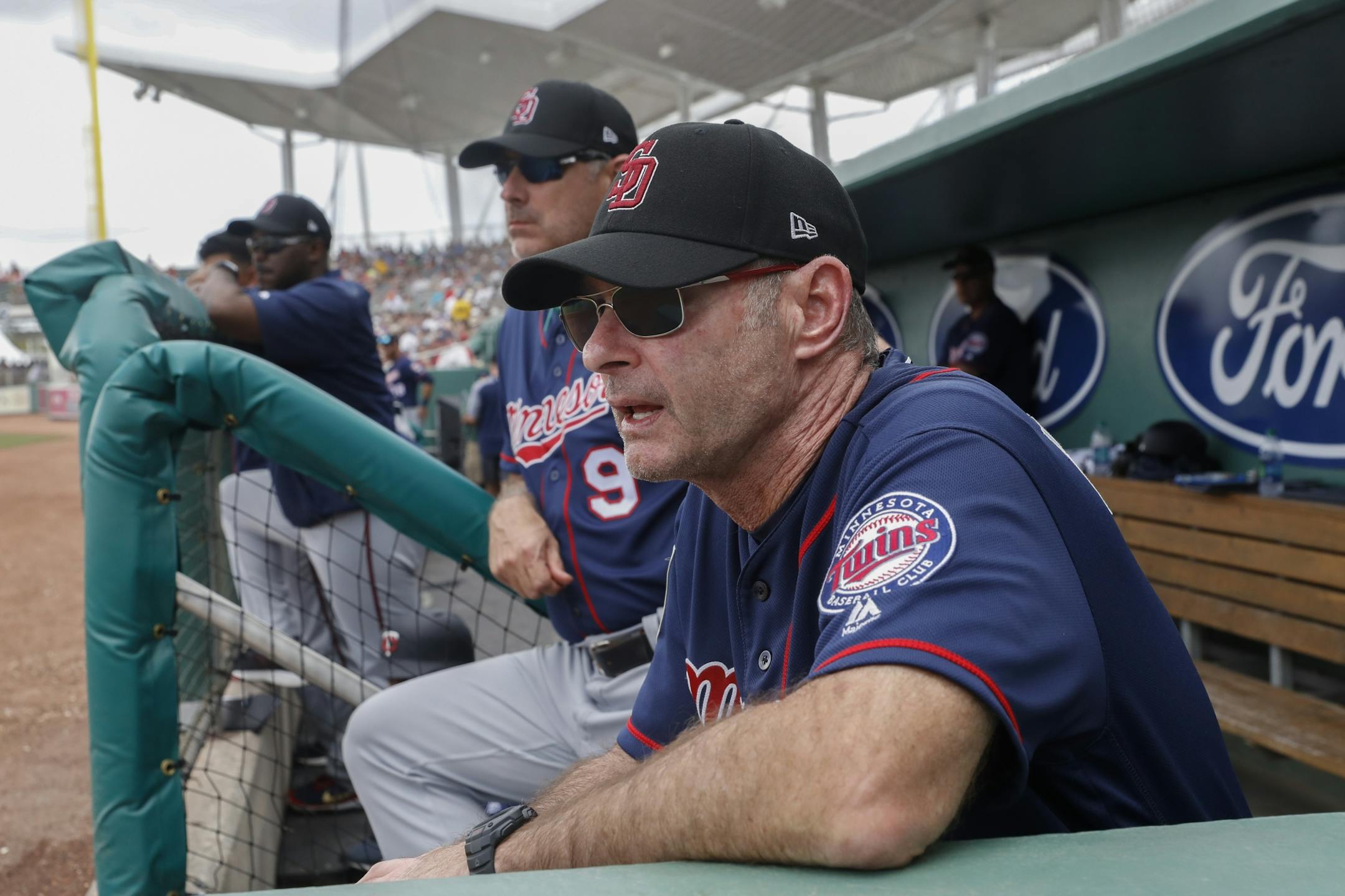 Minnesota Twins manager Paul Molitor works in the dugout in the second inning of a spring training baseball game against the Boston Red Sox, Friday, Feb. 23, 2018, in Fort Myers, Fla.