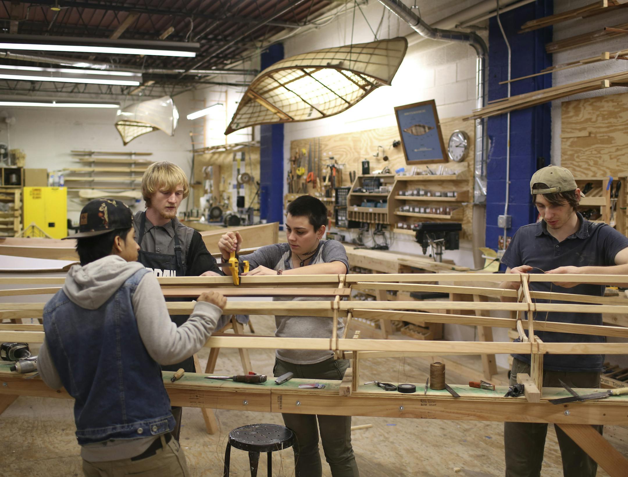 Joseph Romero, Joseph Lefebvre, Lily Vraa, and Jackson Jenkins, from left, were the crew building a kayak Thursday afternoon in the workshop of Urban Boatbuilders in St. Paul. ] JEFF WHEELER ï jeff.wheeler@startribune.com Urban Boatbuilders of St. Paul was among numerous non-profits promoting their programs as part of Give to the Max Day Thursday. Youth apprentices were livestreaming their building a 13 foot skin-on-frame kayak from 7 a.m. to 7 p.m., though it would likely be completed well