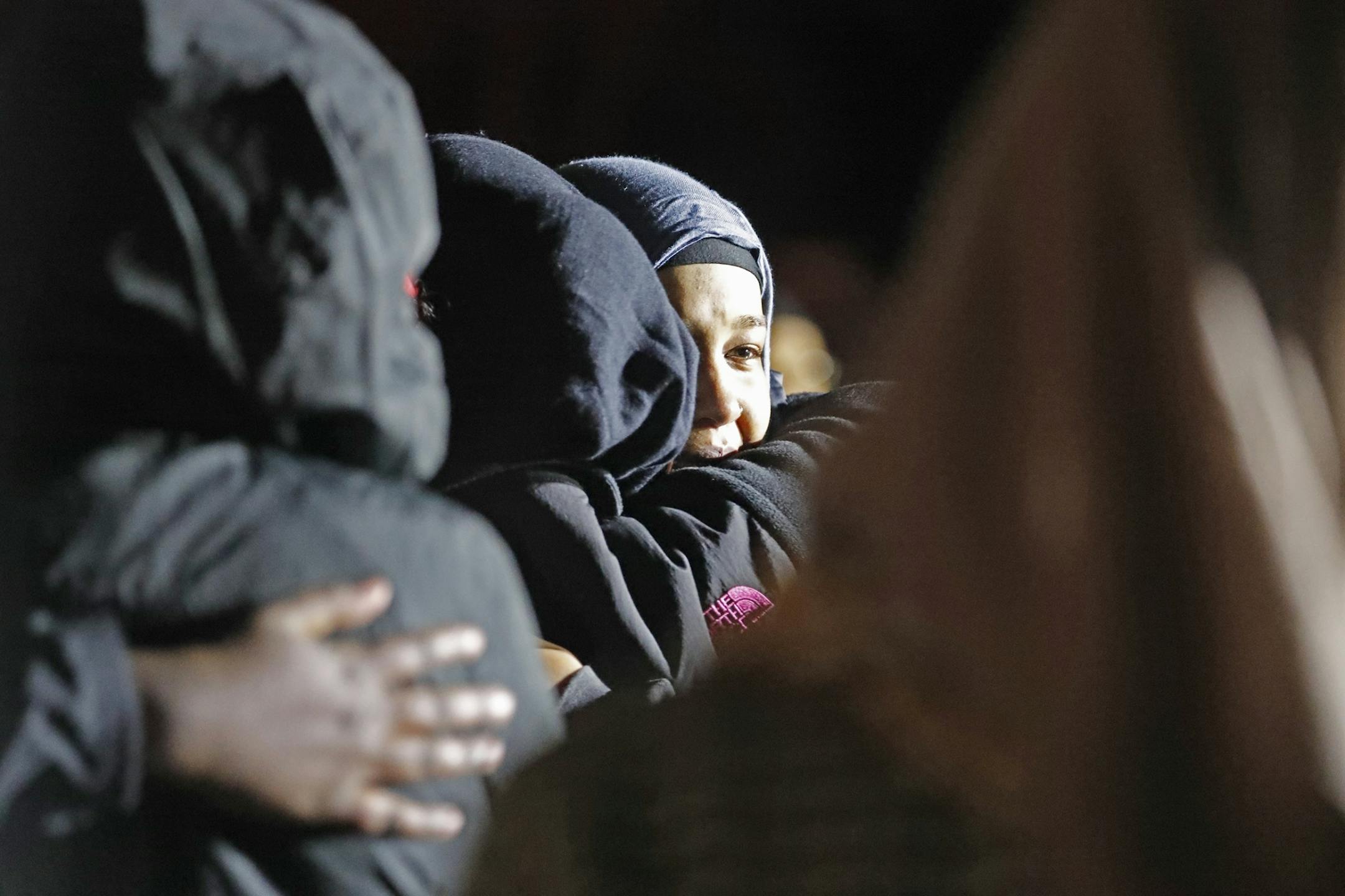 Members of the Somali community grieve at the scene.