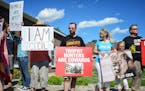 Protesters gathered Wednesday outside River Bluff Dental in Bloomington, owned by Dr. Walter Palmer, who was involved in killing Cecil, a beloved lion