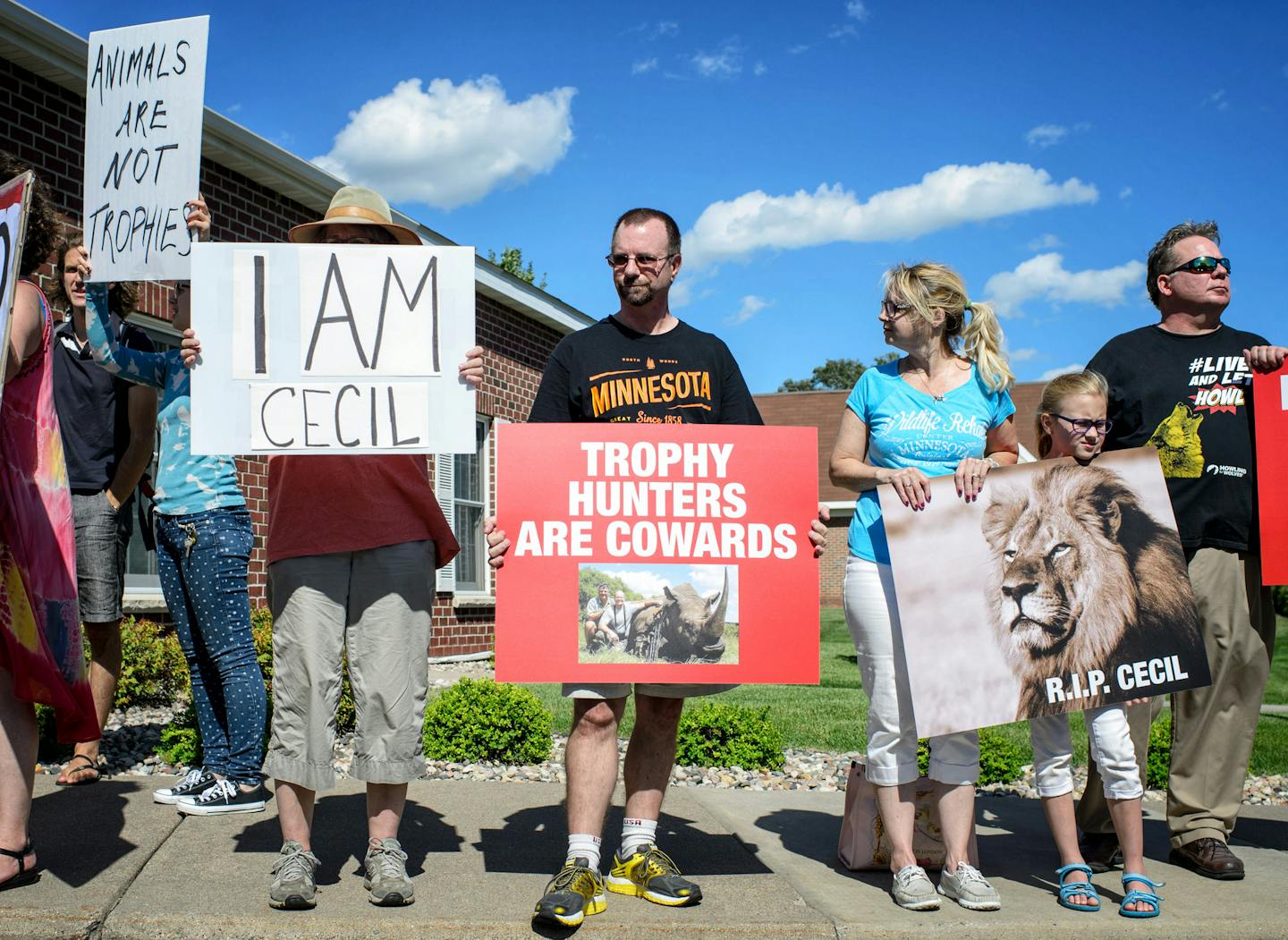 Protesters gathered Wednesday outside River Bluff Dental in Bloomington, owned by Dr. Walter Palmer, who was involved in killing Cecil, a beloved lion in Zimbabwe.