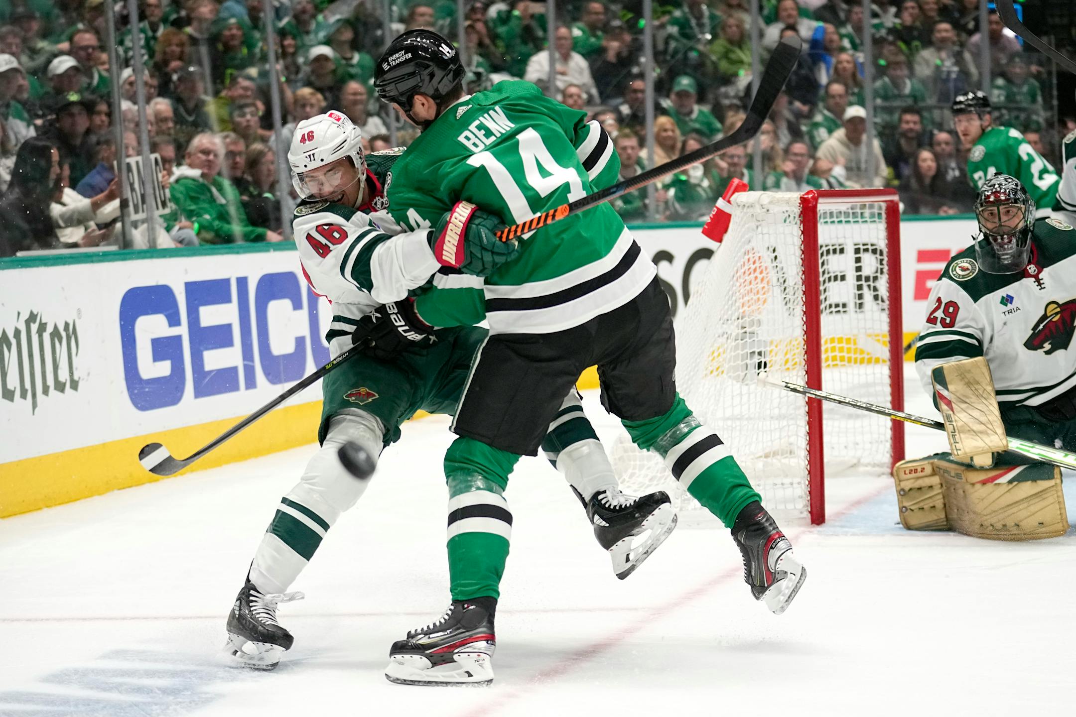 Minnesota Wild defenseman Jared Spurgeon (46) clears the puck before being hit by Dallas Stars' Jamie Benn (14) in the first period of Game 2.