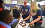 Sano signs a replica jersey for Chelsea Beaver, 29 and her dad Randy Beaver, of Verndale, Minn. at TwinsFest