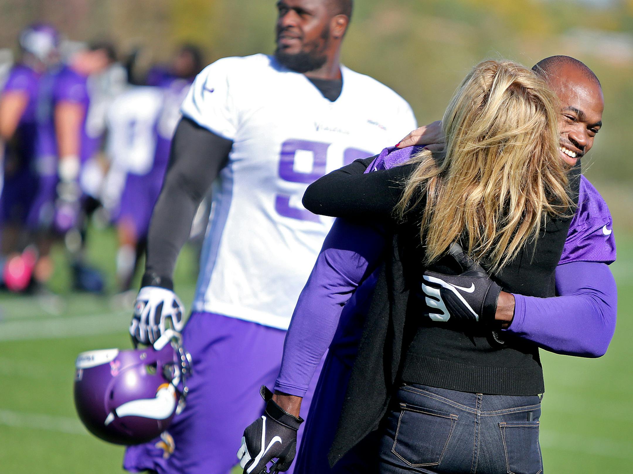 Minnesota Vikings Adrian Peterson received a hug from an unidentified person during practice at Winter Park, Friday, October 11, 2013 in Eden Prairie, MN. Person's 2-year-old son was badly beaten and on life support in Sioux Falls, S.D. (ELIZABETH FLORES/STAR TRIBUNE) ELIZABETH FLORES • eflores@startribune.com