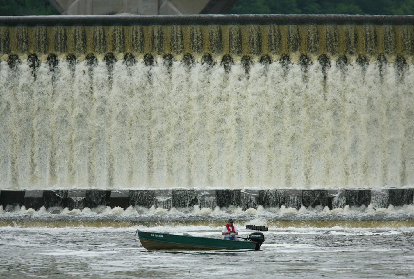 JEFF WHEELER &#x2022; jwheeler@startribune.com ST. PAUL - 5/14/07 - Fish are drawn to the turbulent waters beneath dams along the Mississippi River, as well as the anglers who pursue them, even following the boating mishap that resulted in four deaths below a dam in southern Minnesota over the weekend. IN THIS PHOTO: Woody Jaspersen fished below the Ford Dam on the Mississippi River Monday afternoon after work. He said that now that the water has settled down, he'll be fishing downstream from th