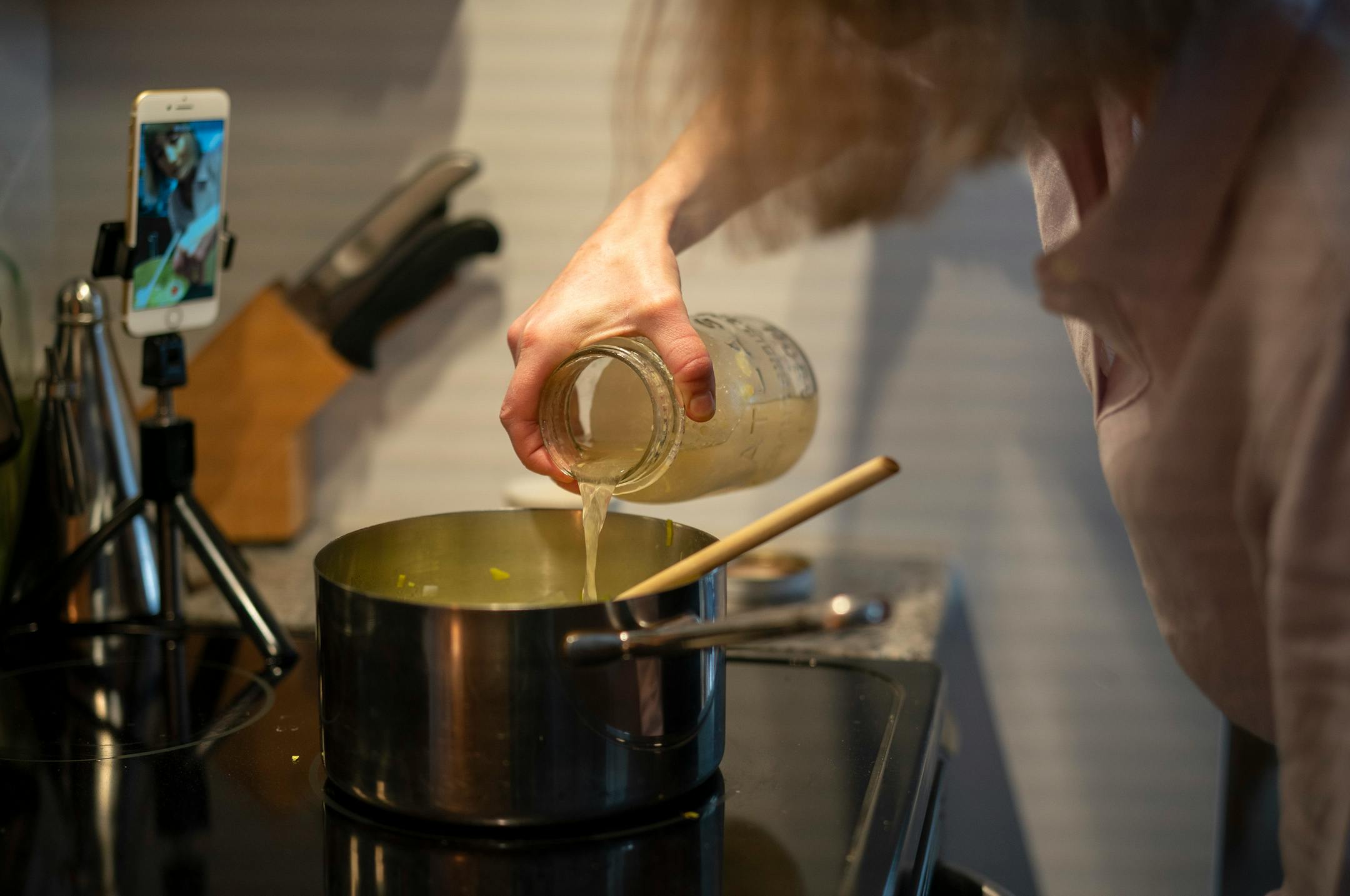 Chef Karyn Tomlinson filmed herself adding chicken stock to the asparagus soup she was showing how to make. Since the pandemic began, former Corner Table chef Karyn Tomlinson has been a prolific poster to Instagram, offering free cooking lessons with her show "Karyn's Quarantine Kitchen." She was photographed producing a segment on preparing pureed soups Thursday afternoon, April 23, 2020 in the kitchen of her condo.