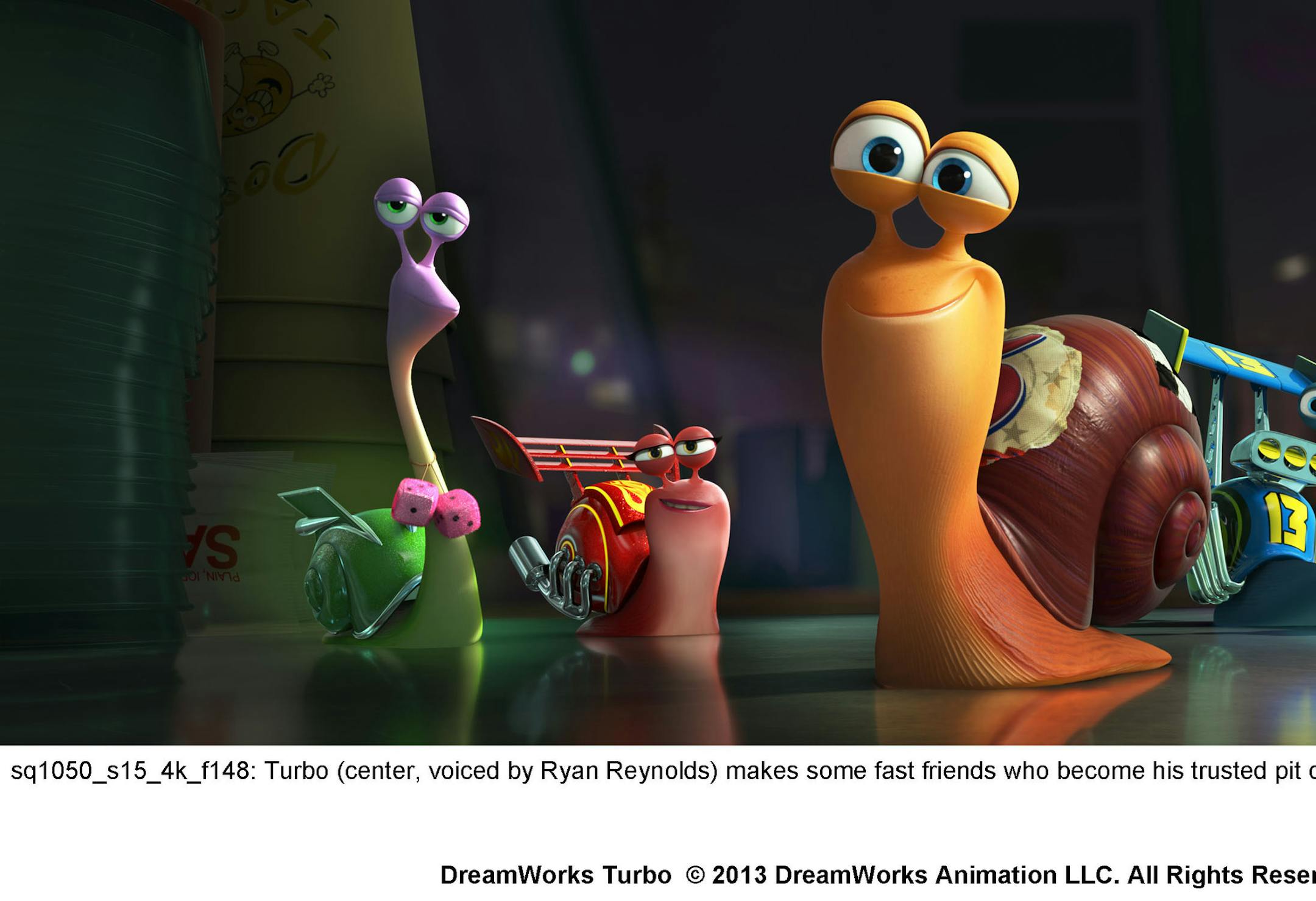 sq1050_s15_4k_f148: Turbo (center, voiced by Ryan Reynolds) makes some fast friends who become his trusted pit crew.