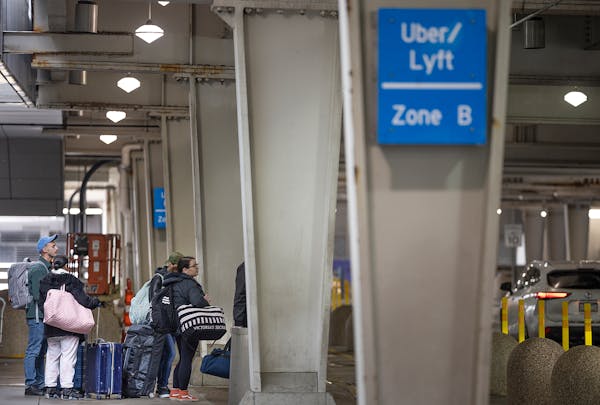 Travelers navigate the Uber/Lyft rideshare area in Terminal 1 at the Minneapolis-St. Paul International Airport in March.