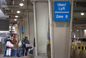 Travelers navigate the Uber/Lyft rideshare area in Terminal 1 at the Minneapolis-St. Paul International Airport in March.