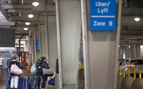 Travelers navigate the Uber/Lyft rideshare area in Terminal 1 at the MSP airport on March 22.