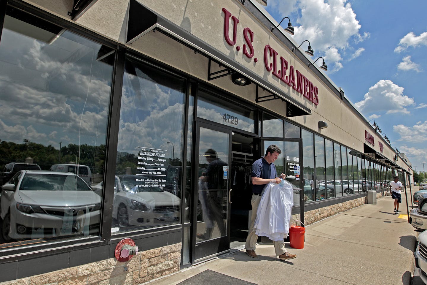 Patrons made their way out of U.S. Cleaners located on a South Minneapolis strip mall, several doors down from a day care, Friday, June 6, 2014 in Minneapolis.