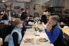Kate Jackson and Michael Pilhofer sat at a communal table at Yum! Kitchen and Bakery in St. Louis Park.