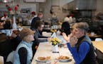 Kate Jackson and Michael Pilhofer sat at a communal table at Yum! Kitchen and Bakery in St. Louis Park.