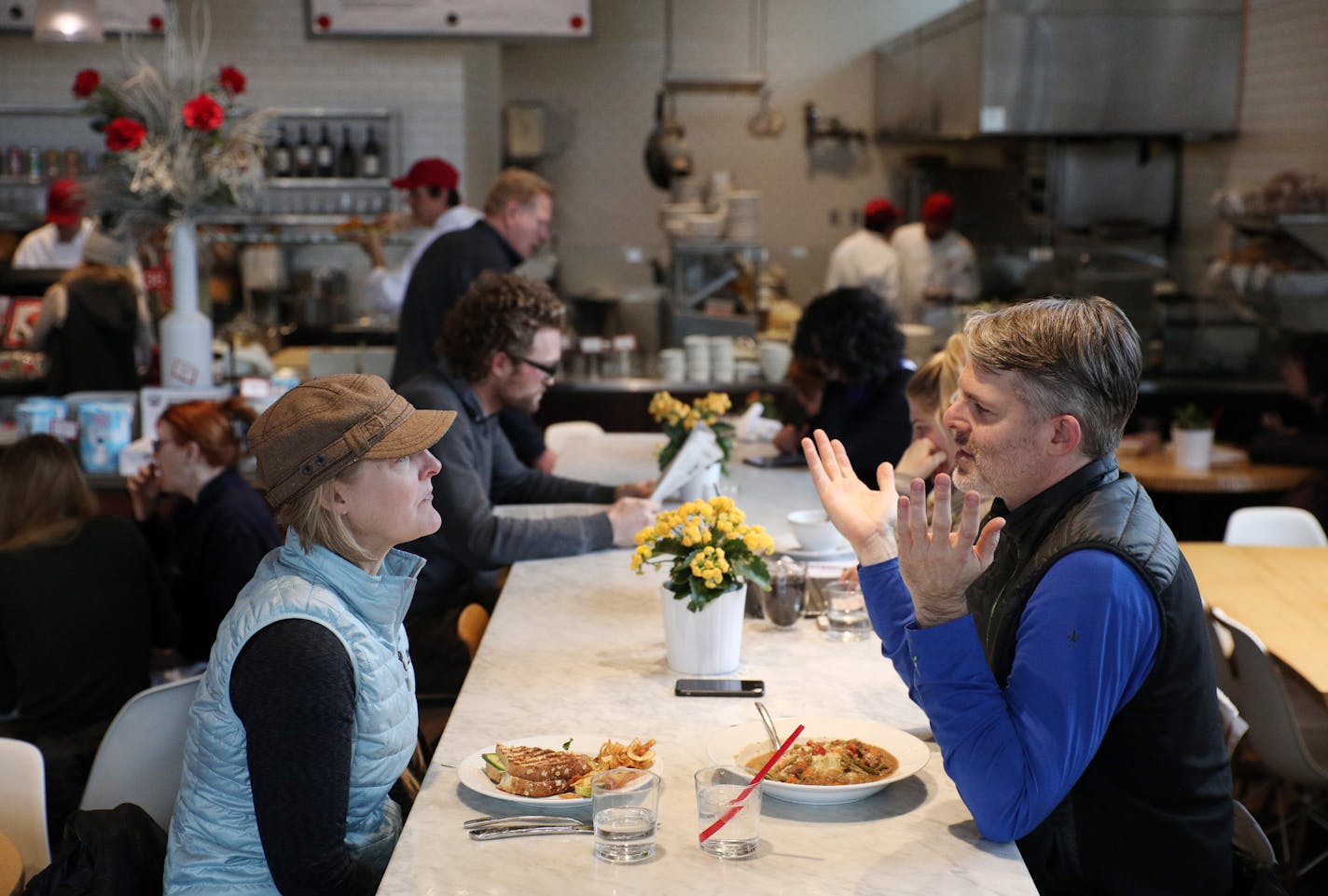 Kate Jackson and Michael Pilhofer sat at a communal table at Yum! Kitchen and Bakery in St. Louis Park.