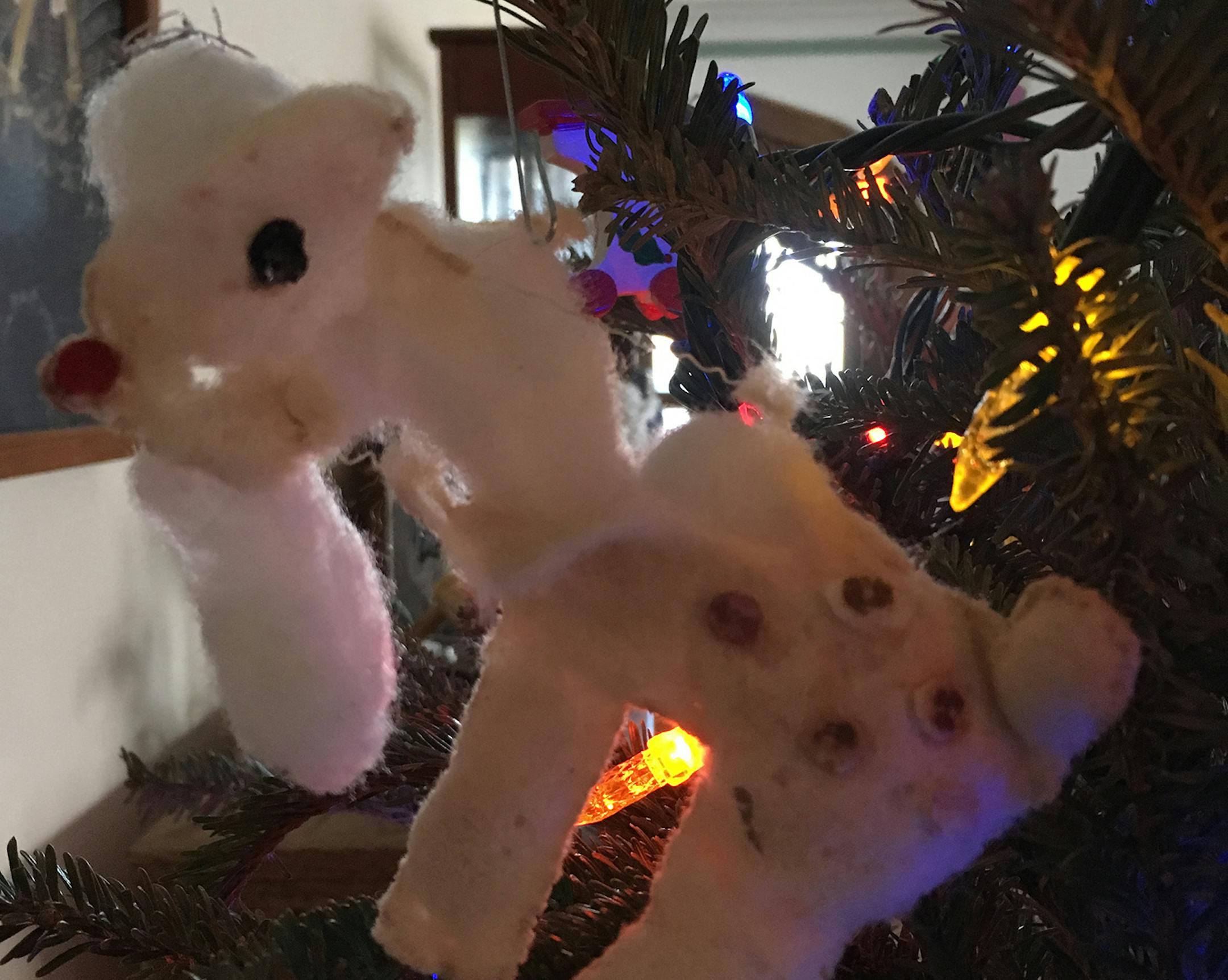 "Mother-in-law made this ornament over 40 years ago.(yup, it's a deer) but as soon as we put it on our tree, our cat, Pumpernickel appropriated it. No matter where we hung it, he'd find it. Every morning during the season we'd find it, a bit more battered, somewhere in the house. He's been gone almost 20 years and we still hang it up."
Mary Hanvik, Minneapolis