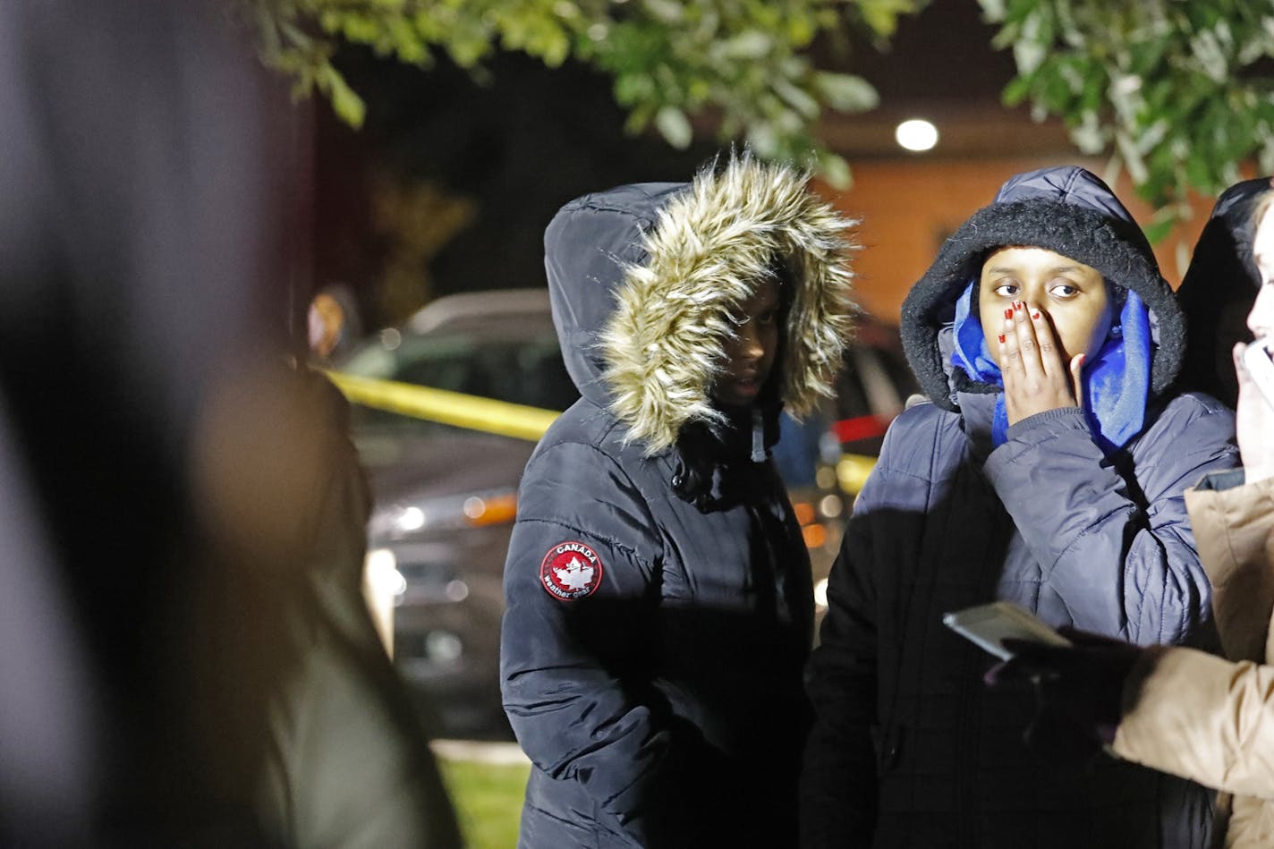 Members of the Somali community grieve at the scene.