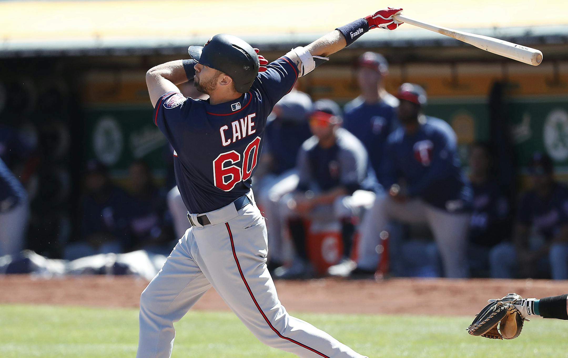 Minnesota Twins' Jake Cave (60) hits a two-run home run against the Oakland Athletics during the first inning of a baseball game in Oakland, Calif., Sunday, Sept. 23, 2018. (AP Photo/Tony Avelar)