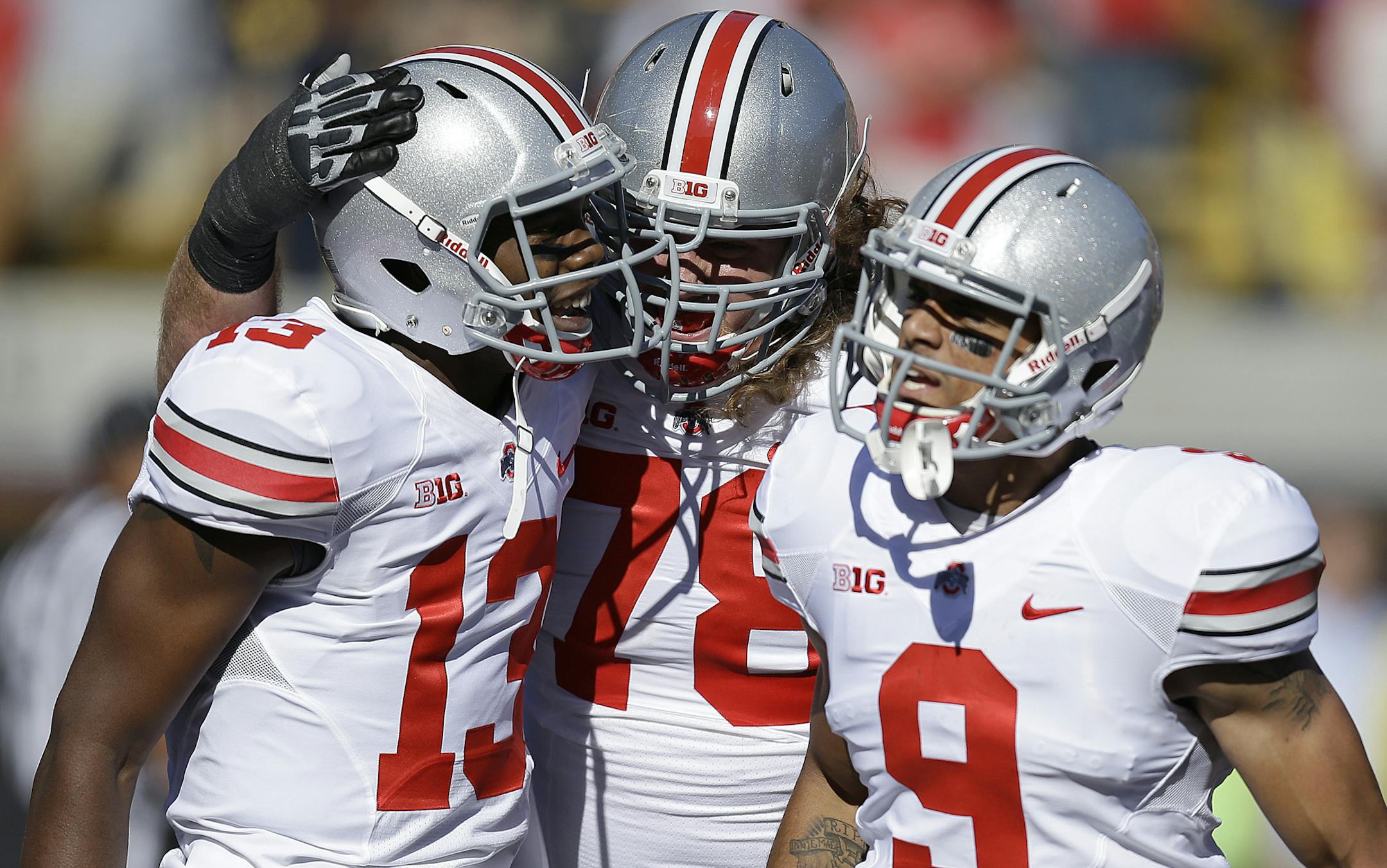 Ohio State's Devin Smith (9), quarterback Kenny Guiton (13) and Andrew Norwell, center, celebrate Smith's touchdown against California during the first quarter of an NCAA college football game, Saturday, Sept. 14, 2013, in Berkeley, Calif.