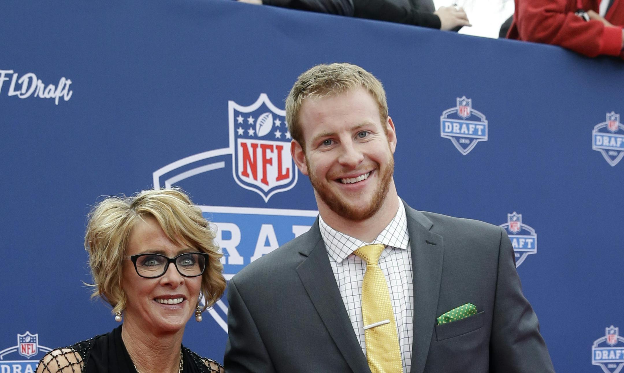 North Dakota State&#xed;s Carson Wentz, right, poses for photos upon arriving for the first round of the 2016 NFL football draft at the Auditorium Theater of Roosevelt University, Thursday, April 28, 2016, in Chicago. (AP Photo/Nam Y. Huh)