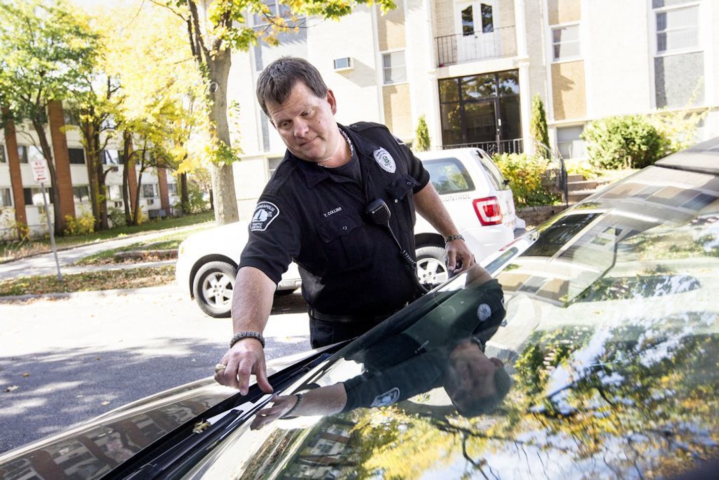 A Minneapolis Traffic Control officer who did not want to be named issued parking tickets during lunch hour on the 3100 block of Girard Avenue South in Minneapolis October 16, 2014. Multiple signs state that only cars with resident permits can park there, but the most ticketed location in the city is 3105 Girard Avenue South.