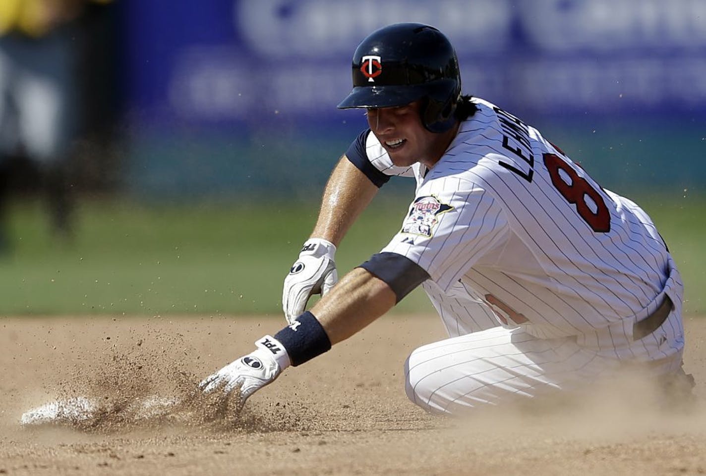 The Twins' Danny Lehmann slid into second base as he is forced out on a hit by Mark Sobolewski in the eighth inning of an exhibition game against Pittsburgh on Sunday. The Pirates won 7-4.