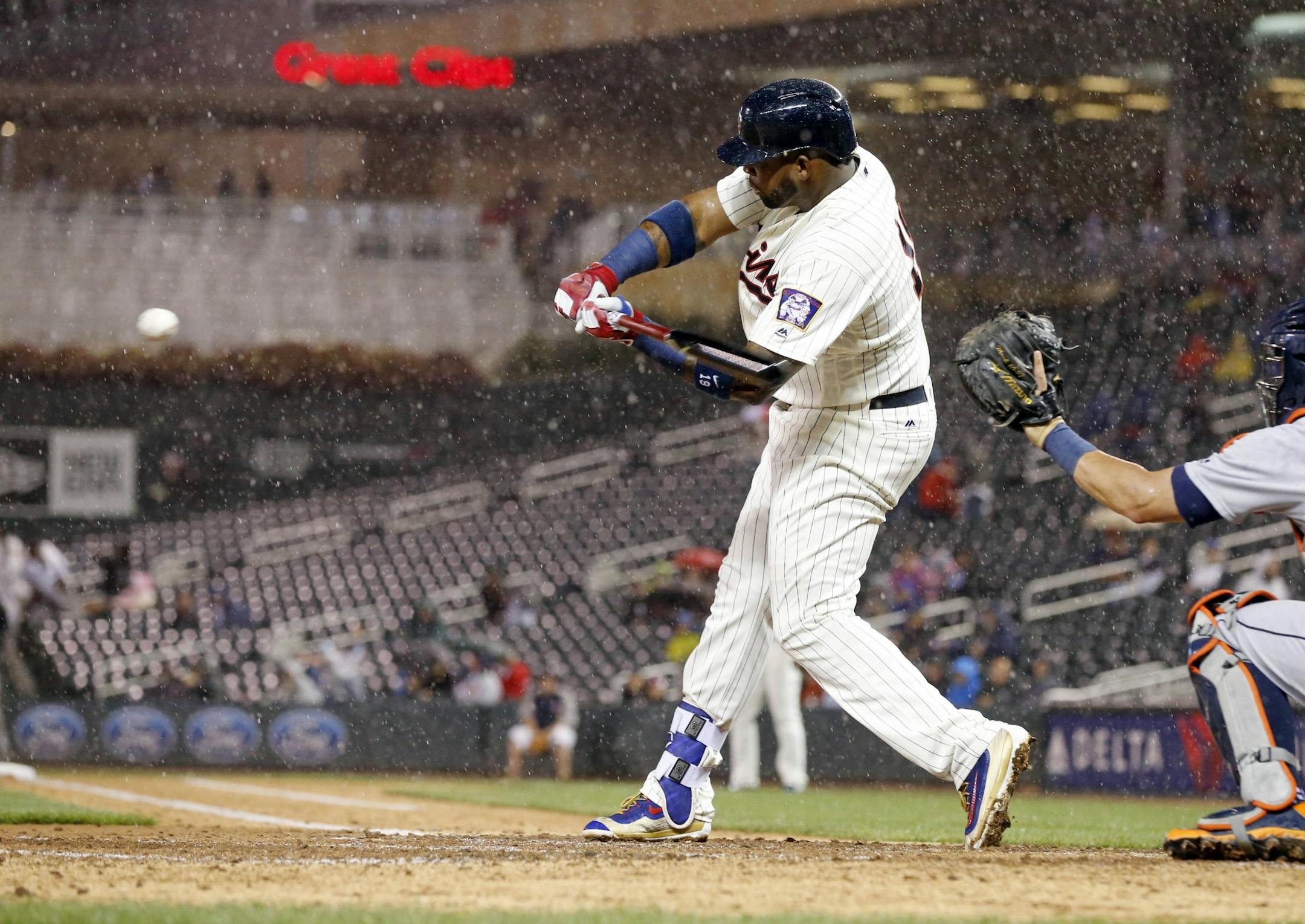 Minnesota Twins' Kennys Vargas swings and strikes out on a pitch from Detroit Tigers pitcher Buck Farmer in the third inning of a baseball game Wednesday, Sept. 21, 2016, in Minneapolis. Moments later, a rain delay was called.