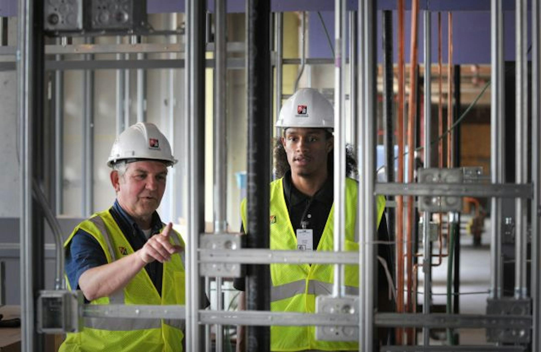 Leandro Dower, a North High School graduate, is in his second year as an intern with Kraus-Anderson and works on the University of Minnesota Amplatz Children's Hospital in Minneapolis. He and project superintendent Bruce Peterson walked through the construction site.