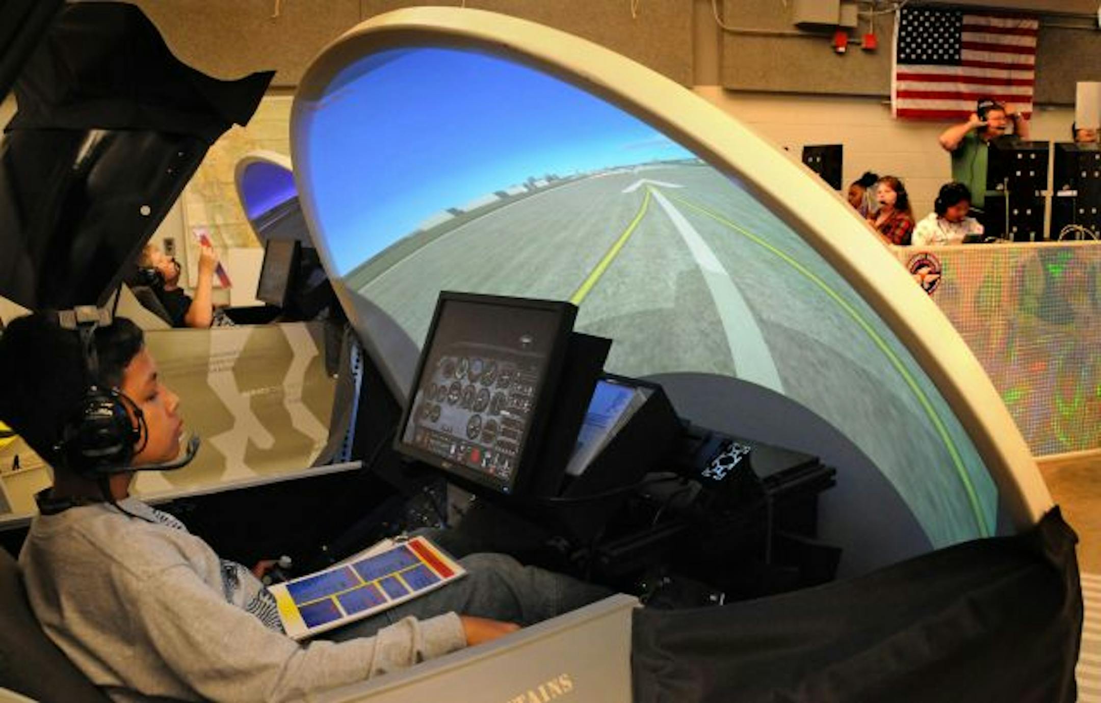 Vithue Chumara, a sixth-grader at Farnsworth Aerospace Secondary School in St. Paul, prepared for takeoff in one of the school's seven flight simulators Tuesday.