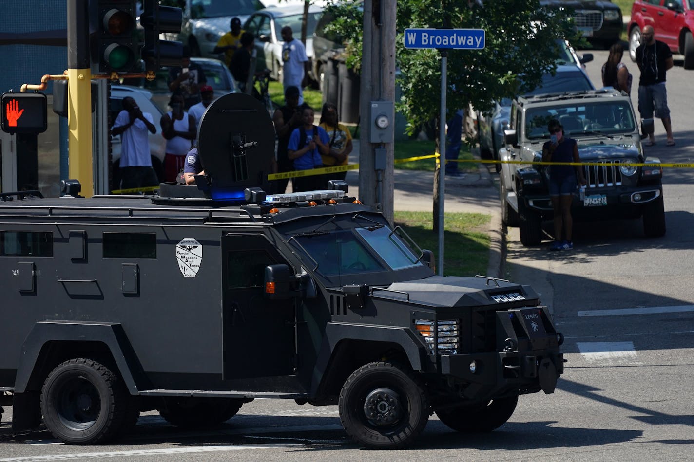 Police secured the scene at the intersection of West Broadway Avenue and Irving Avenue North in north Minneapolis as they used a loudspeaker to negotiate with a suspect they believed was hold up in the building after a shooting earlier in the morning. ] ANTHONY SOUFFLE • anthony.souffle@startribune.com One person was shot Tuesday morning before a standoff with police that stretched into the afternoon until the suspect was brought out in custody Tuesday, June 16, 2020 near the intersection of Wes