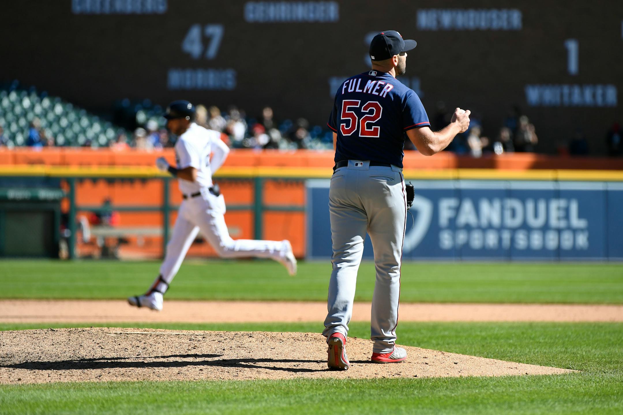 Minnesota Twins relief pitcher Michael Fulmer, right, reacts after giving up a home run to Detroit Tigers' Victor Reyes in the eighth inning of a baseball game, Sunday, Oct. 2, 2022, in Detroit. (AP Photo/Jose Juarez)