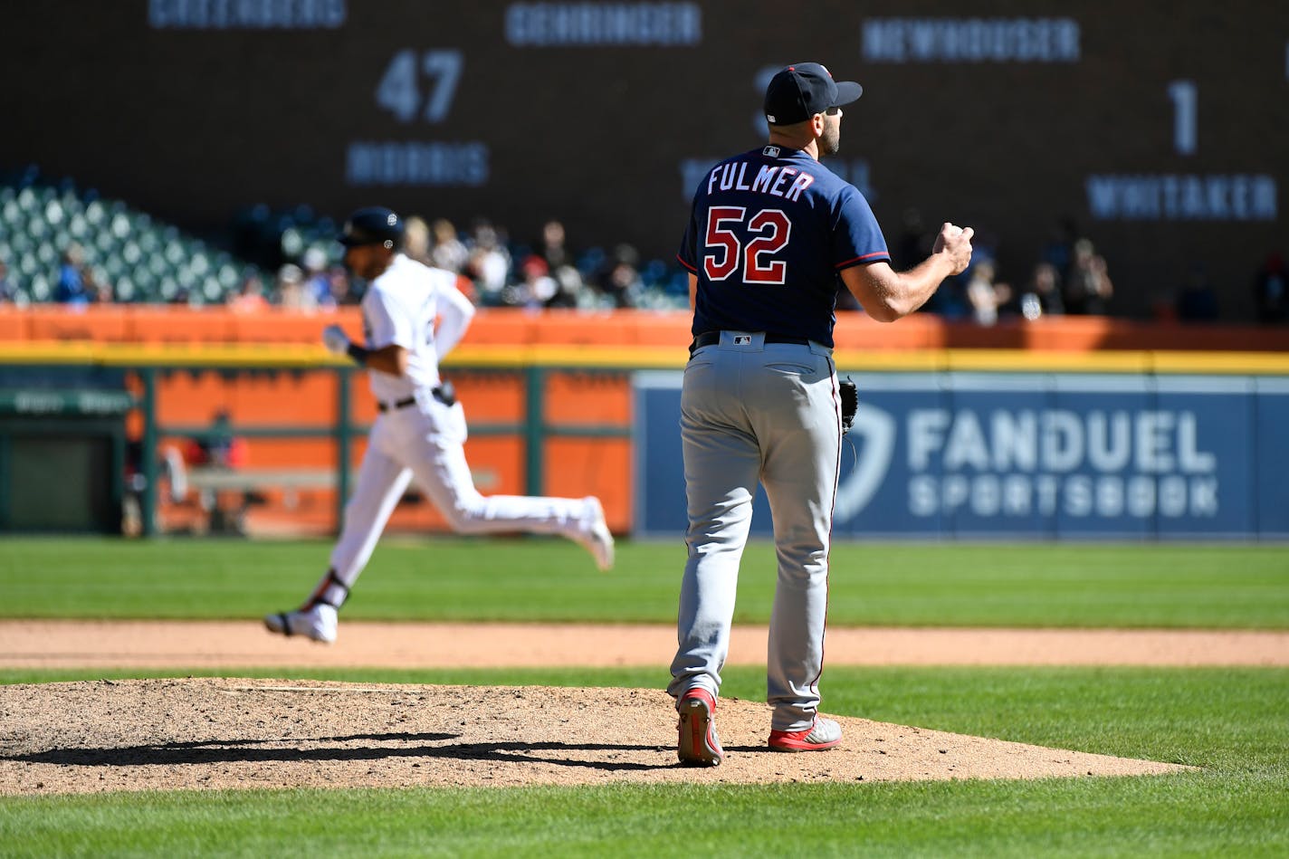 Minnesota Twins relief pitcher Michael Fulmer, right, reacts after giving up a home run to Detroit Tigers' Victor Reyes in the eighth inning of a baseball game, Sunday, Oct. 2, 2022, in Detroit. (AP Photo/Jose Juarez)