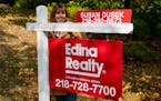 In September, Susan Dusek, a realtor for Edina Realty, posed for a portrait in front of a house for sale in the Congdon Park neighborhood in Duluth.