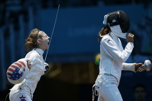 United States' Susie Scanlan, left, reacts during her match against Italy's Nathalie Moellhausen in women's team epee fencing at the 2012 Summer Olymp