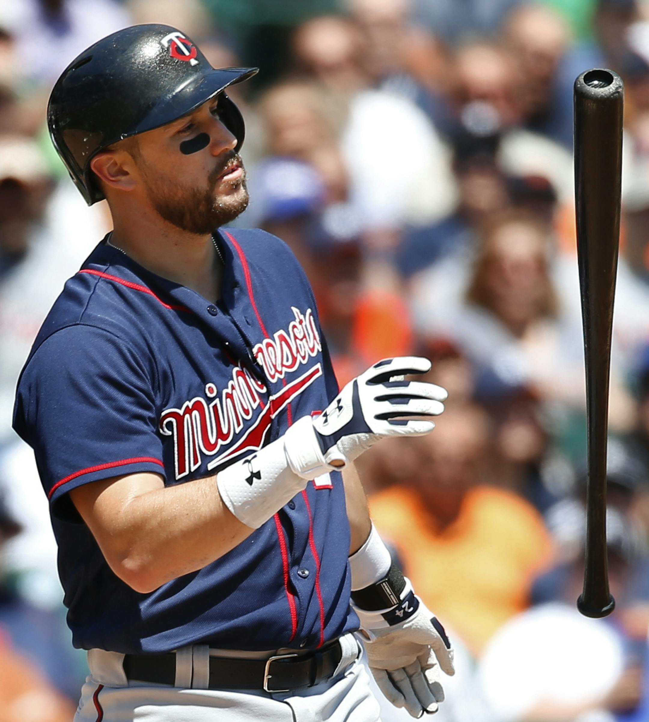 Minnesota Twins' Trevor Plouffe flips his bat after striking out against the Detroit Tigers in the fourth inning of a baseball game in Detroit, Wednesday, May 18, 2016. (AP Photo/Paul Sancya)